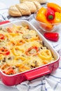 Casserole with potatoes, sausage and colorful bell pepper, in baking dish, vertical Royalty Free Stock Photo