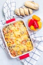 Casserole with potatoes, sausage and colorful bell pepper, in baking dish, vertical, top view Royalty Free Stock Photo