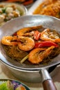 Casseroled prawns with Glass Noodels in Small Iron Pan with Fish, Fried Spring Rolls, Dim Sum, Seafood, Roasted Duck and Meatball Royalty Free Stock Photo