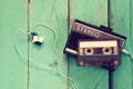 Cassette and old tape player over wooden background. retro filter Royalty Free Stock Photo