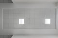 cassette stretched or suspended ceiling with square halogen spots lamps and drywall construction in empty room in house or office
