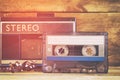 Cassette tape and old player over wooden table. retro filter Royalty Free Stock Photo