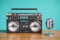 Cassette tape recorder and vintage microphone on wooden table. 3d Royalty Free Stock Photo