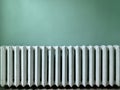 Cast iron batteries in a public building. Old heating radiators on the wall. Radiator sections in the room