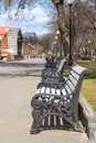 Cast iron bench with wooden slats on the Park alley Royalty Free Stock Photo