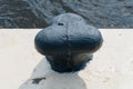 Cast-iron bollard on the embankment as a picturesque backdrop.