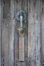 Cast iron or bronze door knocker on an old door. Royalty Free Stock Photo