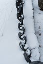 Cast iron chain, a fence under the snow. Winter concept has come. It`s cold. Royalty Free Stock Photo