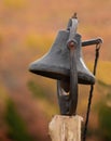 Cast-iron dinner bell in the fall Royalty Free Stock Photo