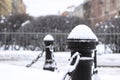 Cast iron fence posts with chains, covered with snow Royalty Free Stock Photo