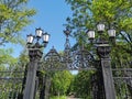 Cast-iron grating, fence, gates and lanterns in the Summer Garden of Kronstadt against the background of a blue cloudless sky Royalty Free Stock Photo