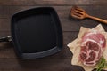 Cast iron griddle pan and beef steak wood on wooden background. Top view, Copy space. Royalty Free Stock Photo