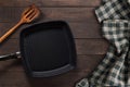 Cast iron griddle pan and turner wood on wooden background. Top view, Copy space. Royalty Free Stock Photo