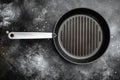 Cast iron grill pan with copy space for text or food with copy space for text or food, top view flat lay , on black dark stone Royalty Free Stock Photo