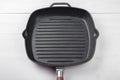 Cast-iron grill pan on a wooden surface Royalty Free Stock Photo