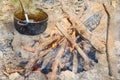 A cast-iron kettle next to the campfire. An empty cauldron with Royalty Free Stock Photo