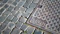 Cast iron manhole cover with SPQR engraving on a stone floor with a geometric design