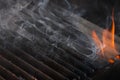 Cast iron metal grill grate with fire and smoke Royalty Free Stock Photo