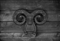 Cast iron ornament on a light wooden wall. Toned Royalty Free Stock Photo
