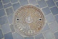 Cast iron ornamented manhole cover in Budapest, Hungary. Closeup of duct manhole cover with Budapest Coat of Arms at the Old Town