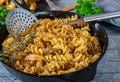 Pan dish with fried minced meat, pasta and cabbage