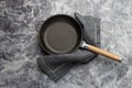 Empty cast iron frying pan on dark grey culinary background, view from above Royalty Free Stock Photo