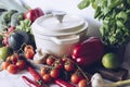 Cast iron pot and vegetables on rustic table. Homemade food, cooking, vegetarian concept Royalty Free Stock Photo