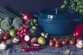 Cast iron pot and vegetables on rustic table. Homemade food, cooking, vegetarian concept Royalty Free Stock Photo