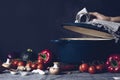 Cast iron pot and vegetables on rustic table. Homemade food, cooking, vegetarian concept Royalty Free Stock Photo