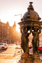 Cast iron public fountain with caryatid female figures in Barcelona