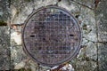 Cast iron round sewer pit. Rainwater installation in the city Royalty Free Stock Photo