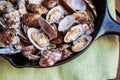 Cast iron skillet of Delicious Fresh Steamer Clams with Garlic a Royalty Free Stock Photo