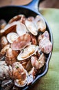 Cast iron skillet of Delicious Fresh Steamer Clams with Garlic a Royalty Free Stock Photo