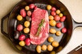 Cast iron skillet salt and pepper raw organic steak meat