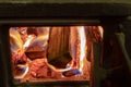 in a cast iron stove burning wood, close-up Royalty Free Stock Photo