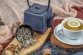 Still life with traditional sage tea prepared in vintage cast iron teapot on rustic wooden table. Retro filter Royalty Free Stock Photo