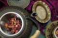 A cast iron teapot kettle with a cup of Rose tea and some rose petals Royalty Free Stock Photo