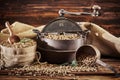 Cast iron vintage coffee roaster with raw beans