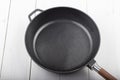 Cast-iron wok pan on a white table Royalty Free Stock Photo