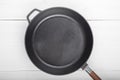 Cast-iron wok pan on a white table Royalty Free Stock Photo