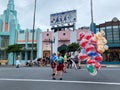 A cast member selling balloons at the entrance at the Hollywood Studios Park at Walt Disney World