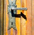 castellanza blur brown knocker in a door c wood italy cross Royalty Free Stock Photo