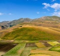 Castelluccio di Norcia, in Umbria, Italy. Fields and hills, sunny day. Colourful landscape. Royalty Free Stock Photo