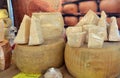 Castelnuovo, Piedmont, Italy -11-27-2022- Wheels and slices Parmigiano Reggiano e Grana Padano in Italian market