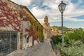 CASTIGLIONE DELLA PESCAIA, ITALY - SEPTEMBER 30, 2016: small street on a side hill with house overgrown with ivy and vintage Royalty Free Stock Photo