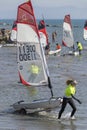 female contestant carrying her boat out of water at Open Skiff regatta, Castiglione della Pescaia, Italy