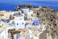 Castillo area with castle and byzantine ruins and greek flag in oia