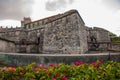 Castillo de la Real Fuerza. The old fortress Castle of the Royal Force and flower bed with red colors. Havana, Cuba. Royalty Free Stock Photo