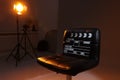 Casting call. Chair, clapperboard and different equipment in modern studio