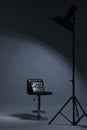 Casting call. Chair, clapperboard and lamp in modern studio